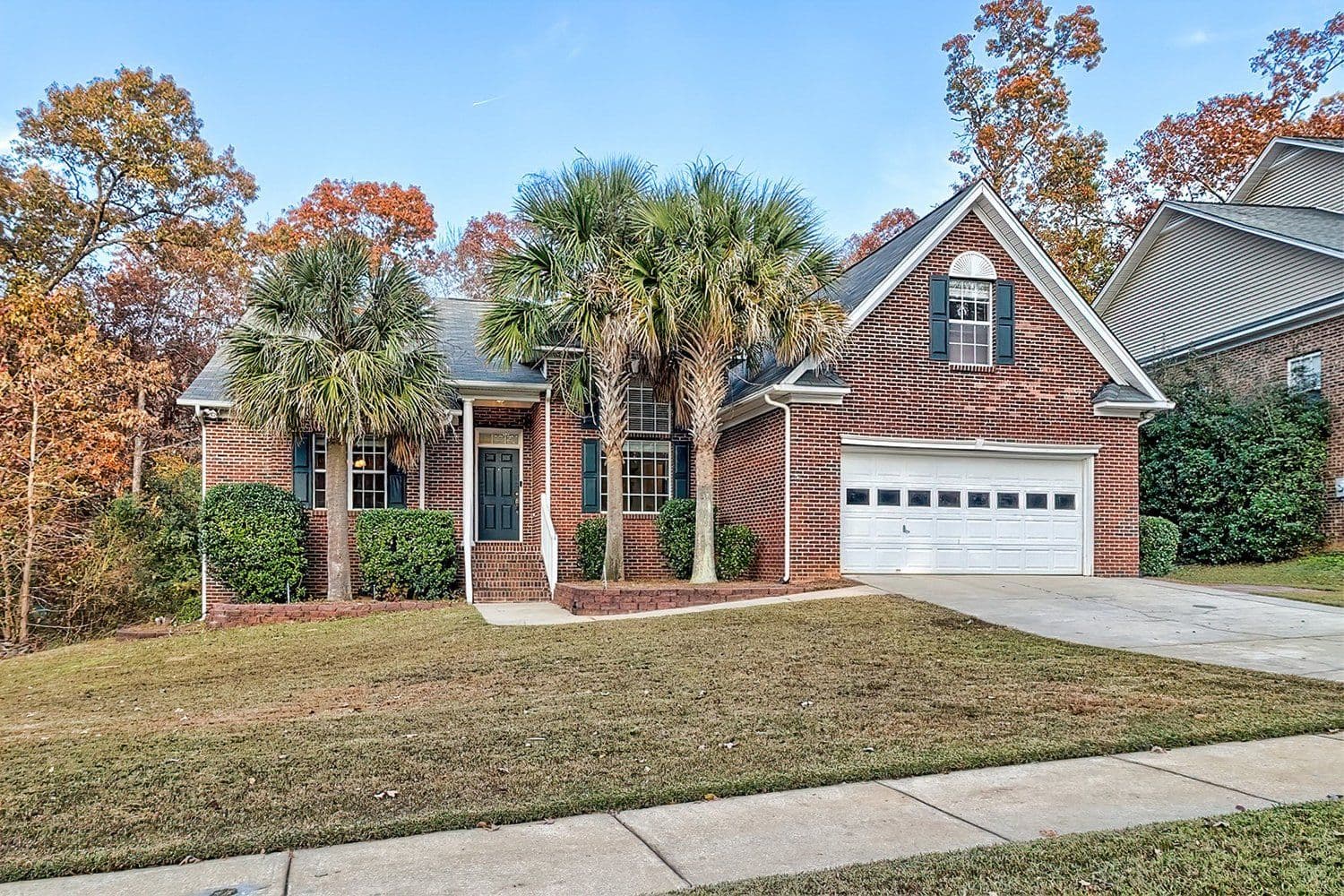 Brick home with palm trees in the front yard