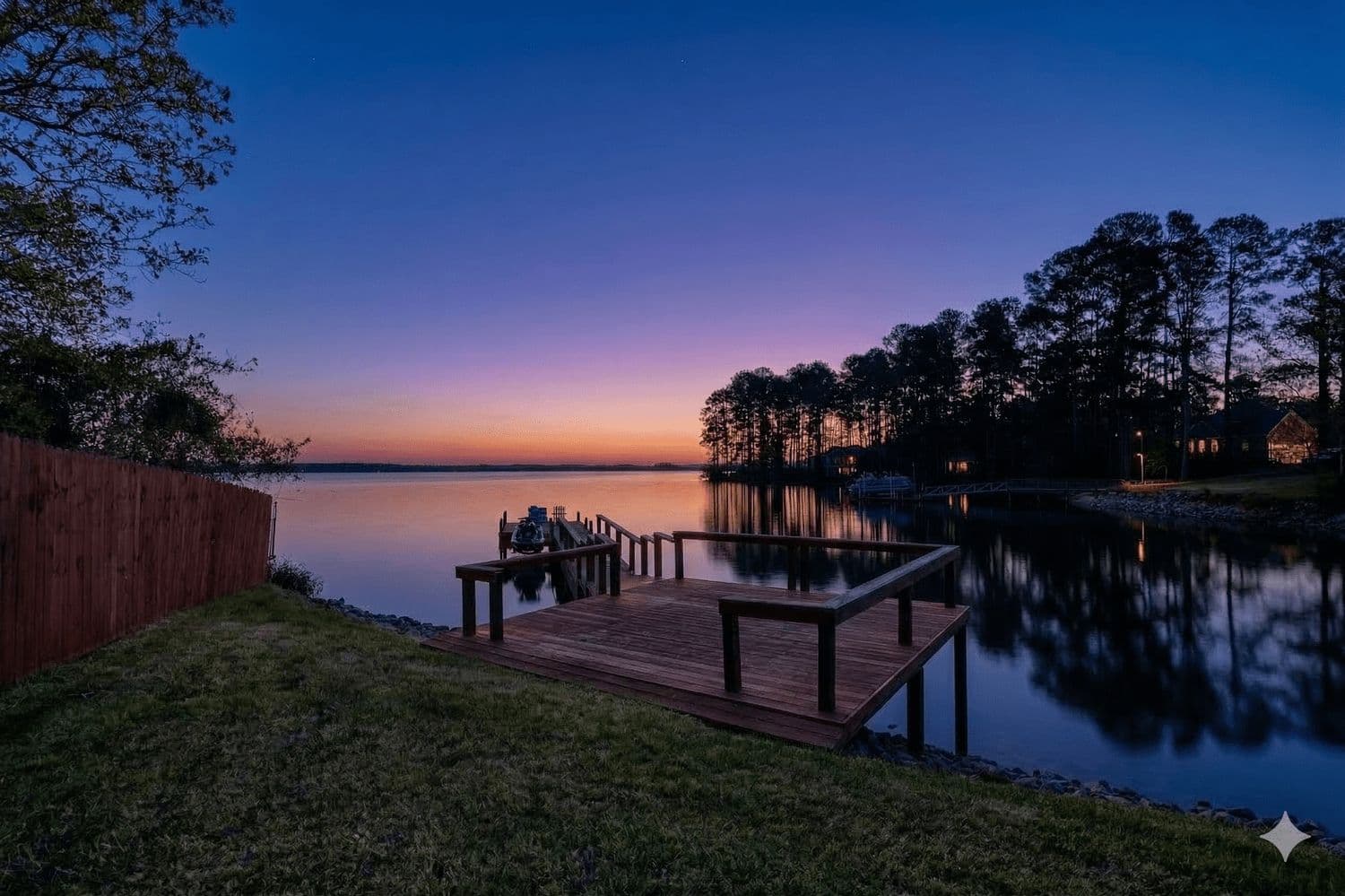 Wooden dock extending into a lake at sunset