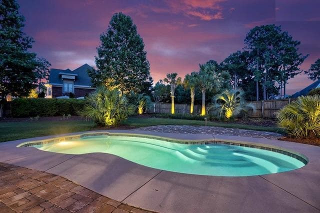 A backyard pool at dusk