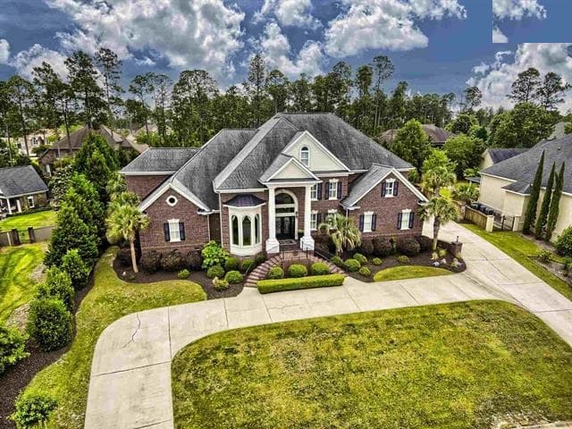 A brick home with a white portico