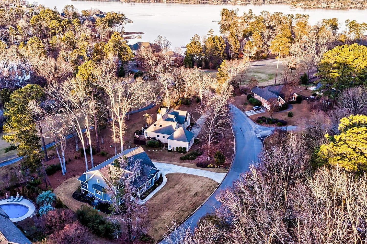 Aerial of a residential area with autumn trees near water