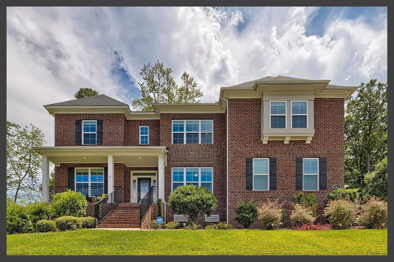 Large two-story brick family home with a two-car garage