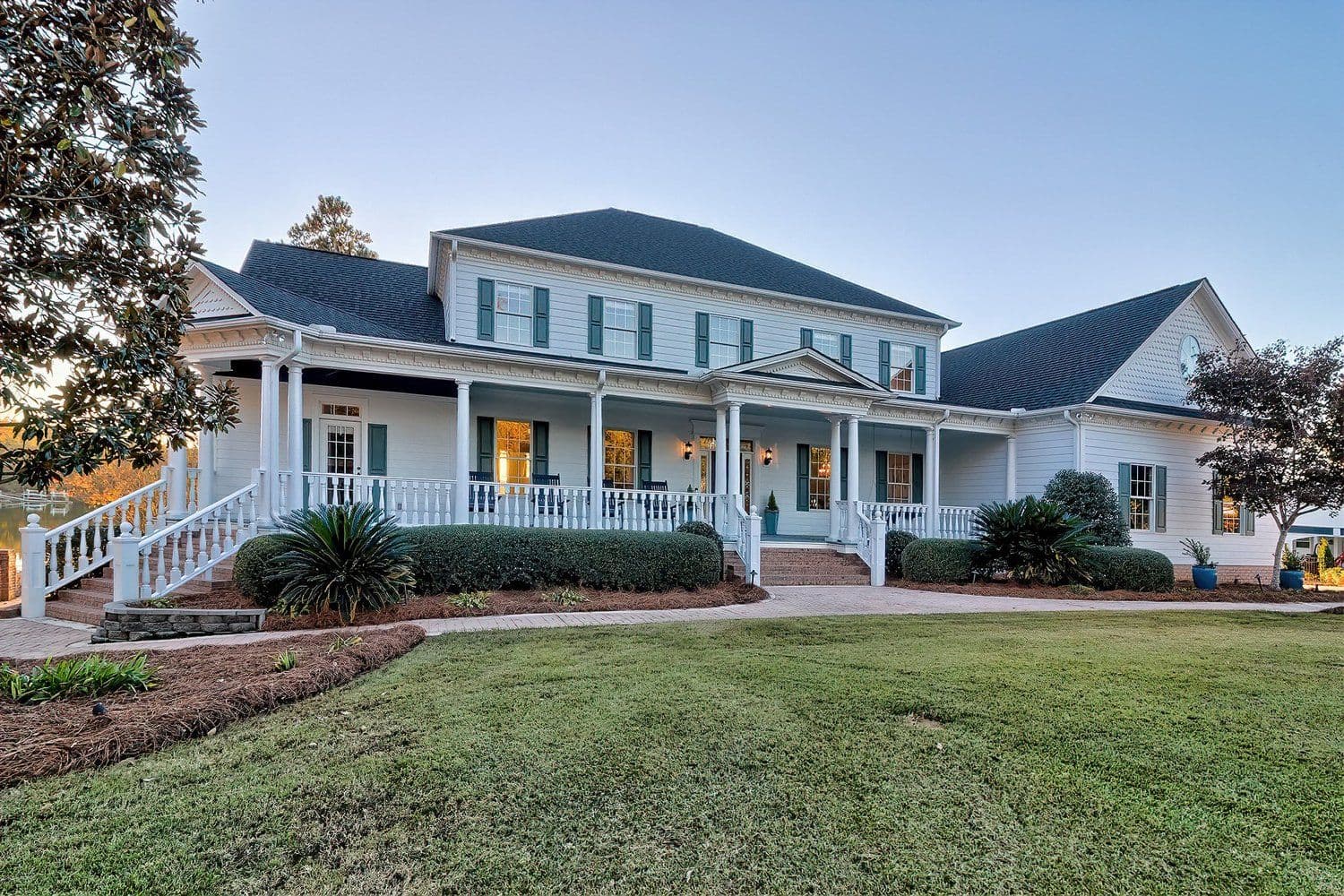 Large white house with a sprawling front porch