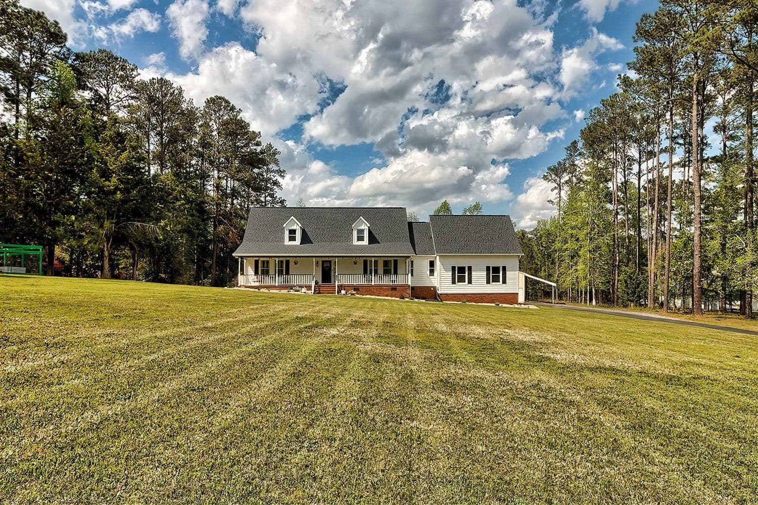 Large white two-story house with a wide lawn
