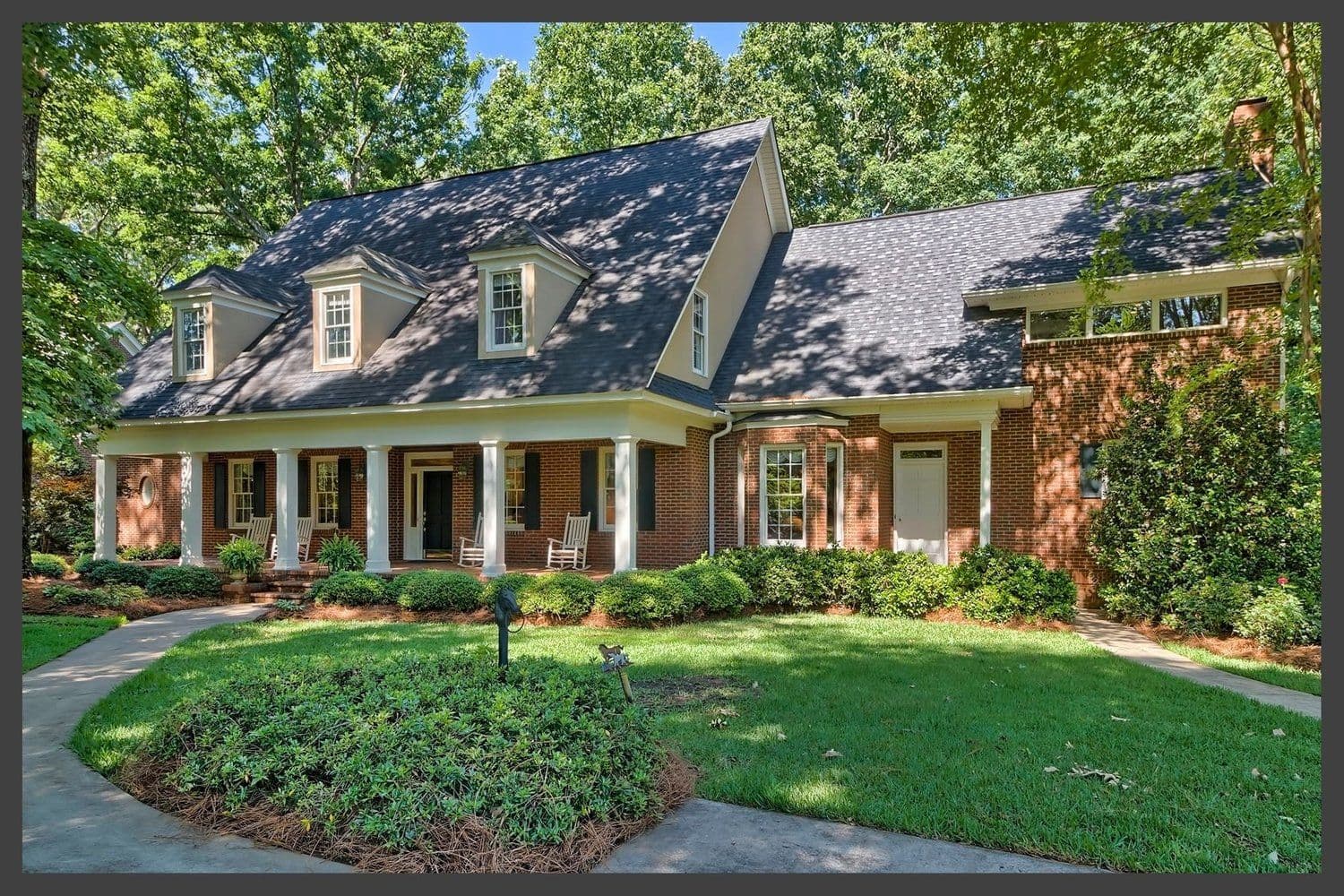 Long single-story brick home with dormer windows