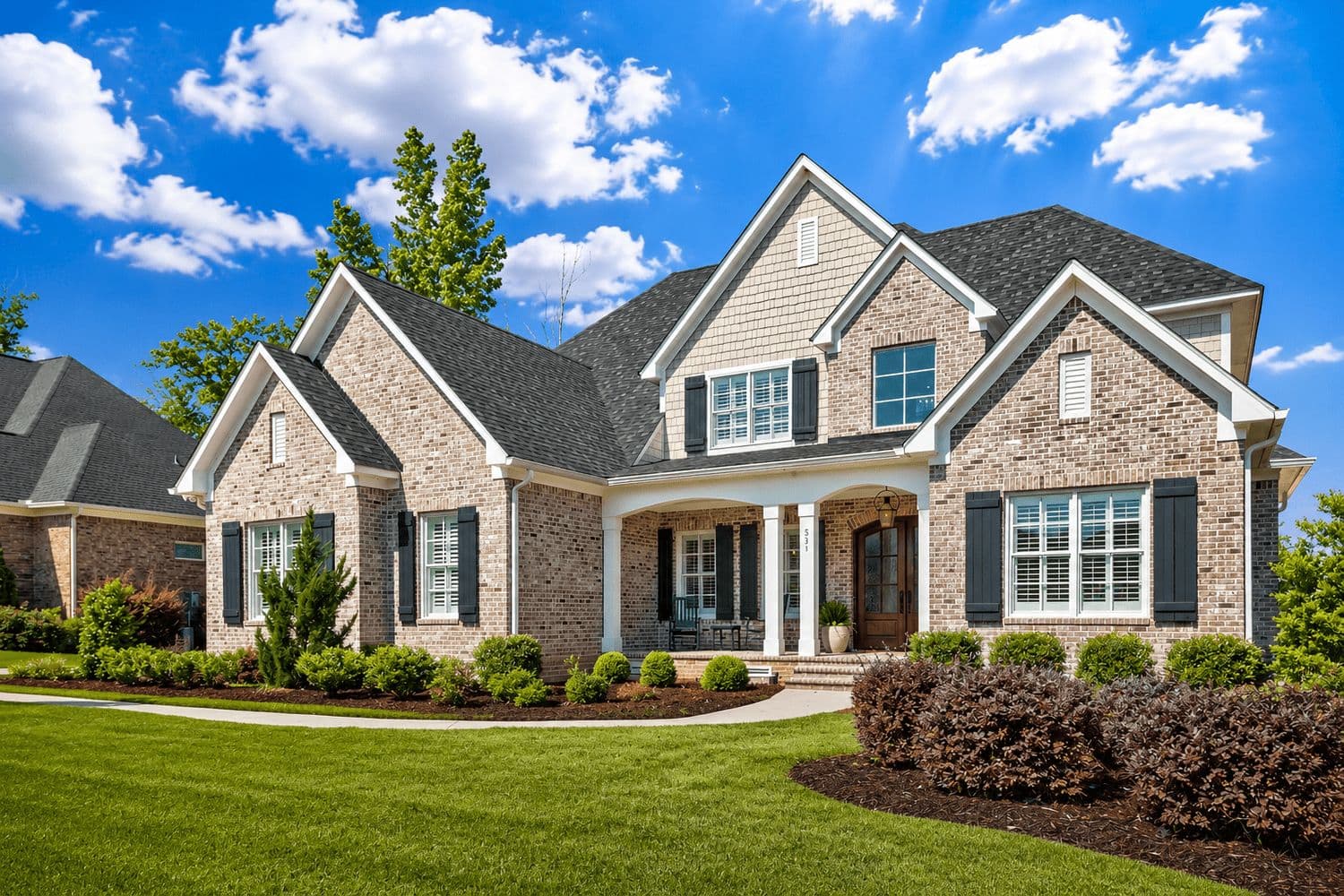 Modern craftsman home with stone accents and a multi-gabled roof