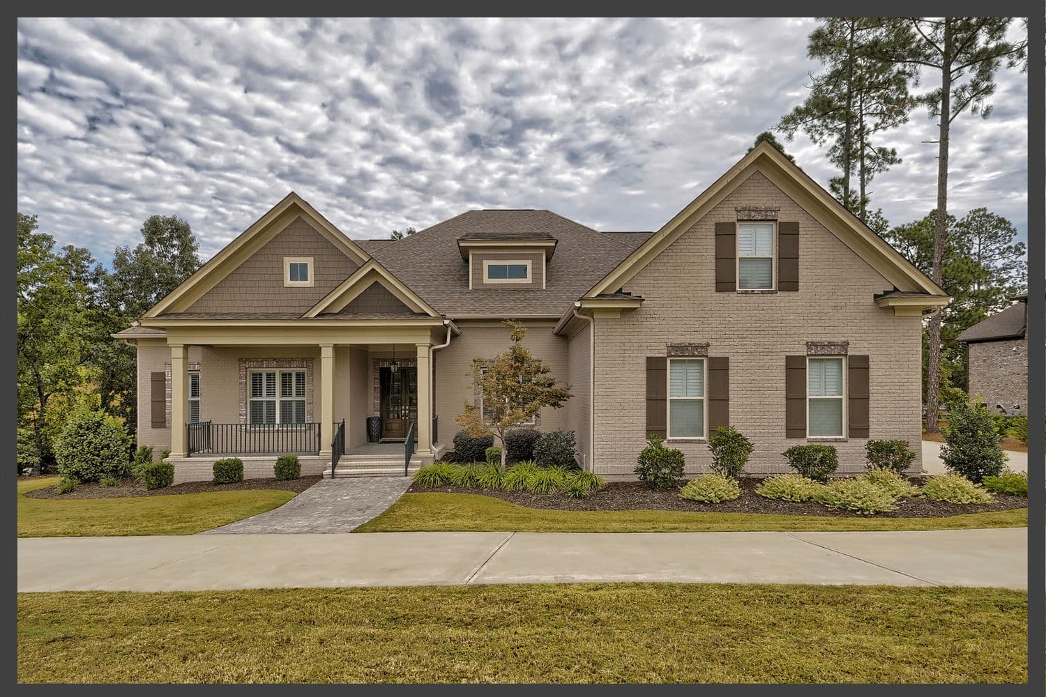 Modern craftsman home with tan siding and stone accents