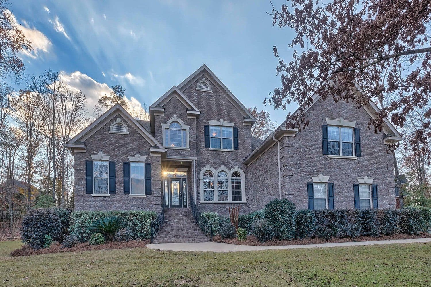 Modern two-story home with brick and dark siding and multiple gables
