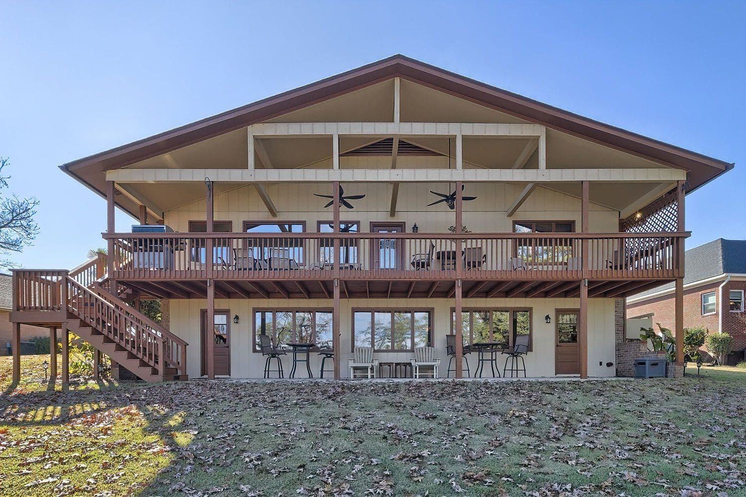Rear exterior of a large home with a multi-level wooden balcony