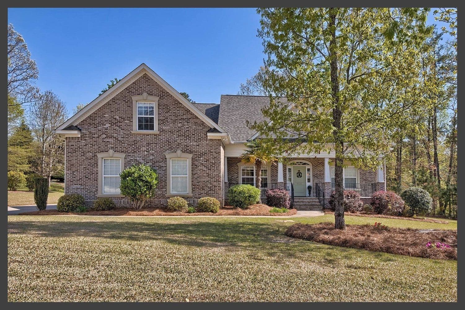 Sprawling one-story brick home with a large front lawn