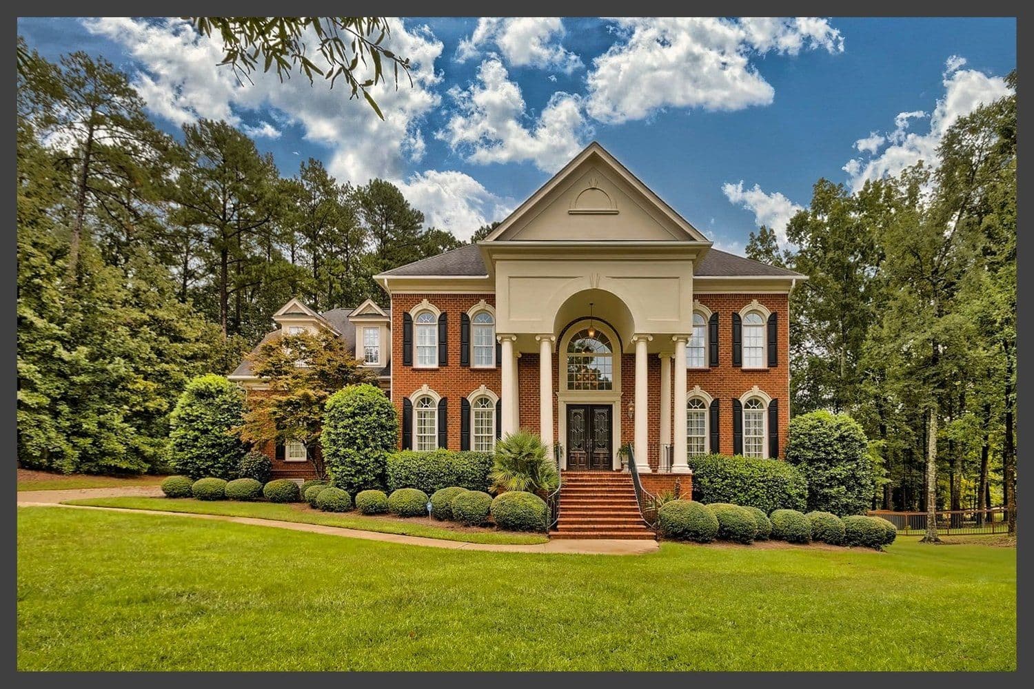 Stately two-story brick house with four tall white columns