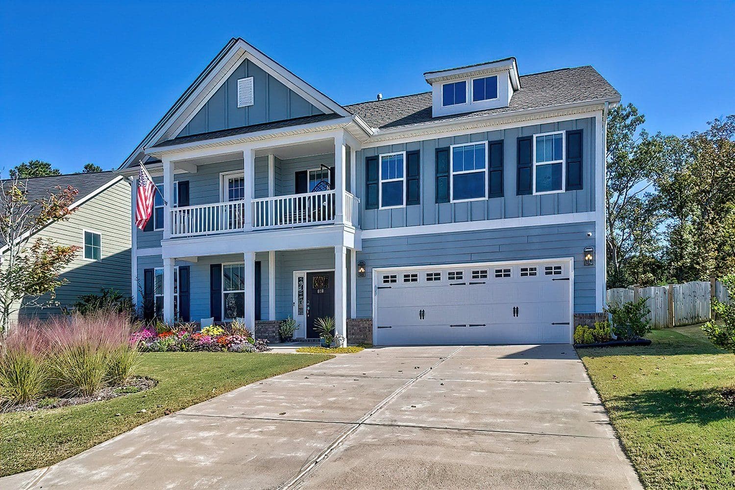 Two-story blue house with a three-car garage