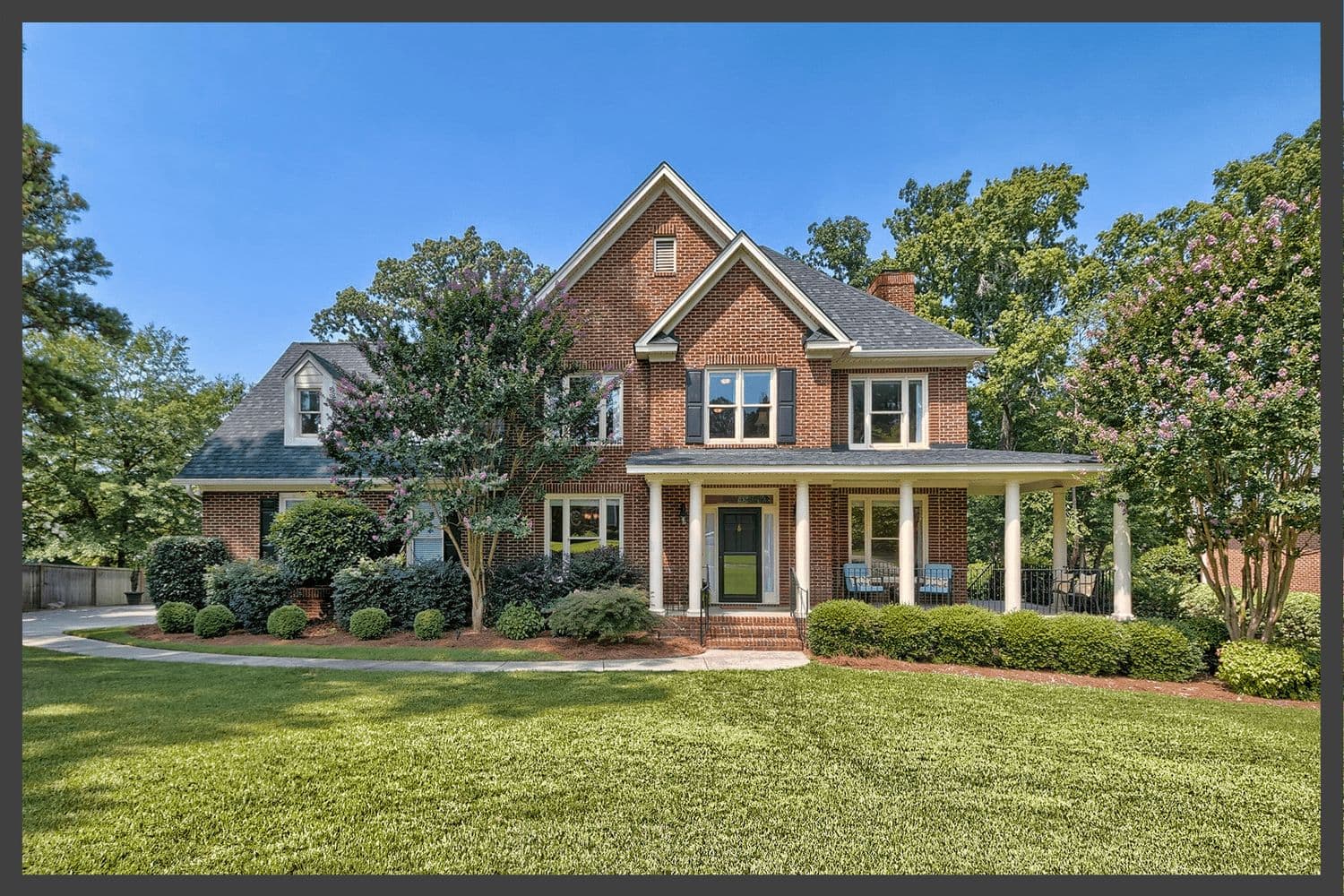 Two-story brick home with a white columned front porch