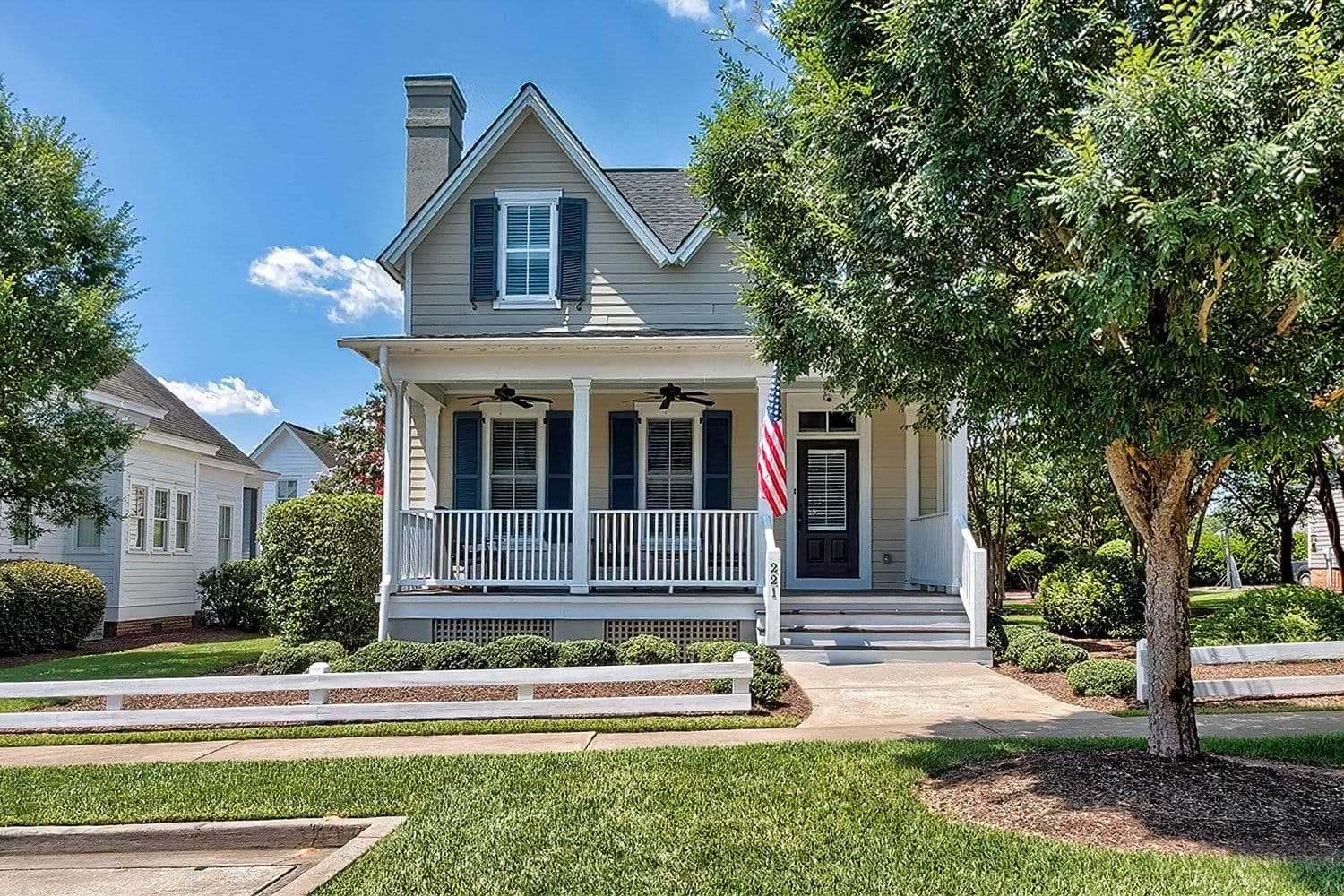 Two-story house with a front porch and white railings