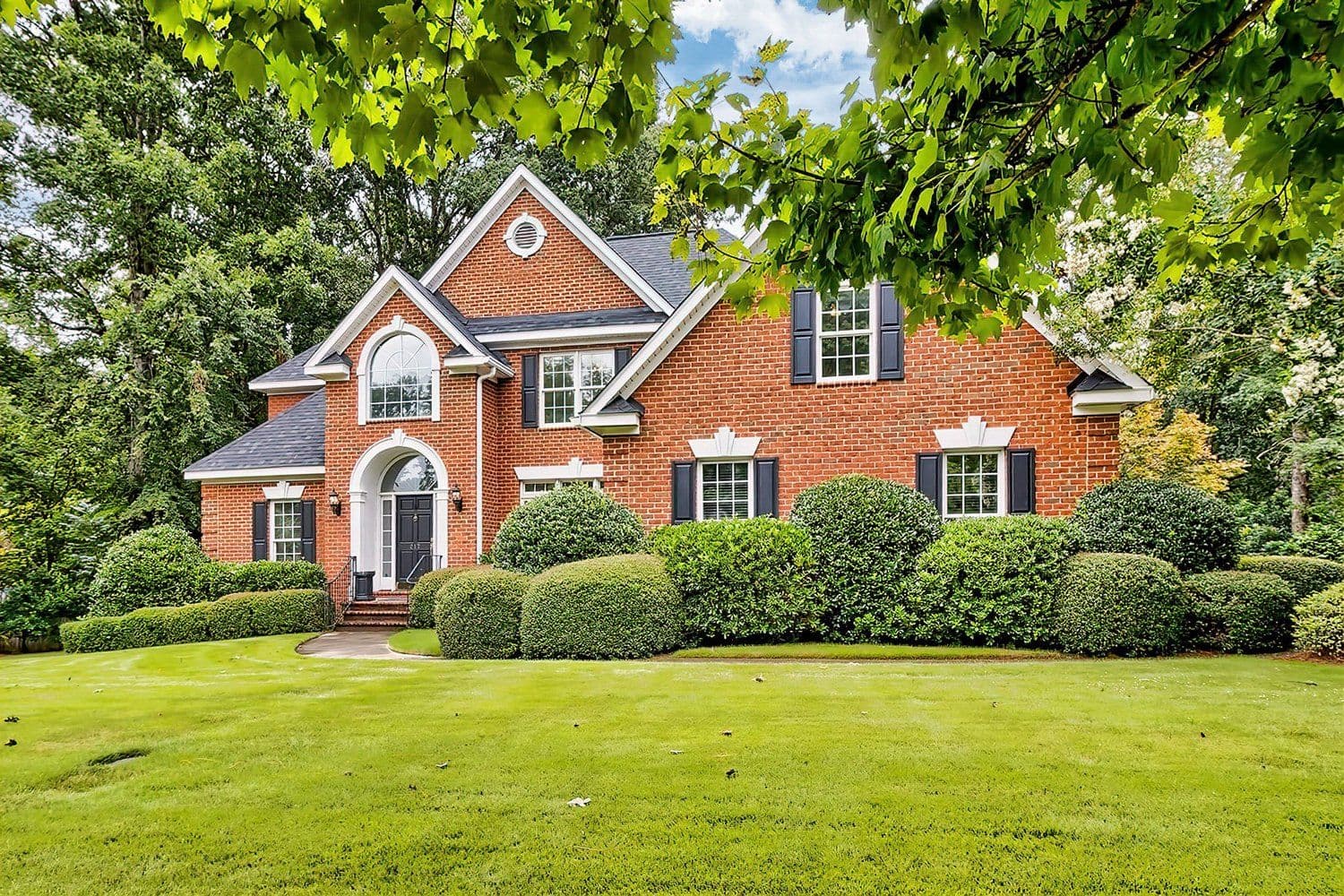 Two-story red brick house with multiple gables