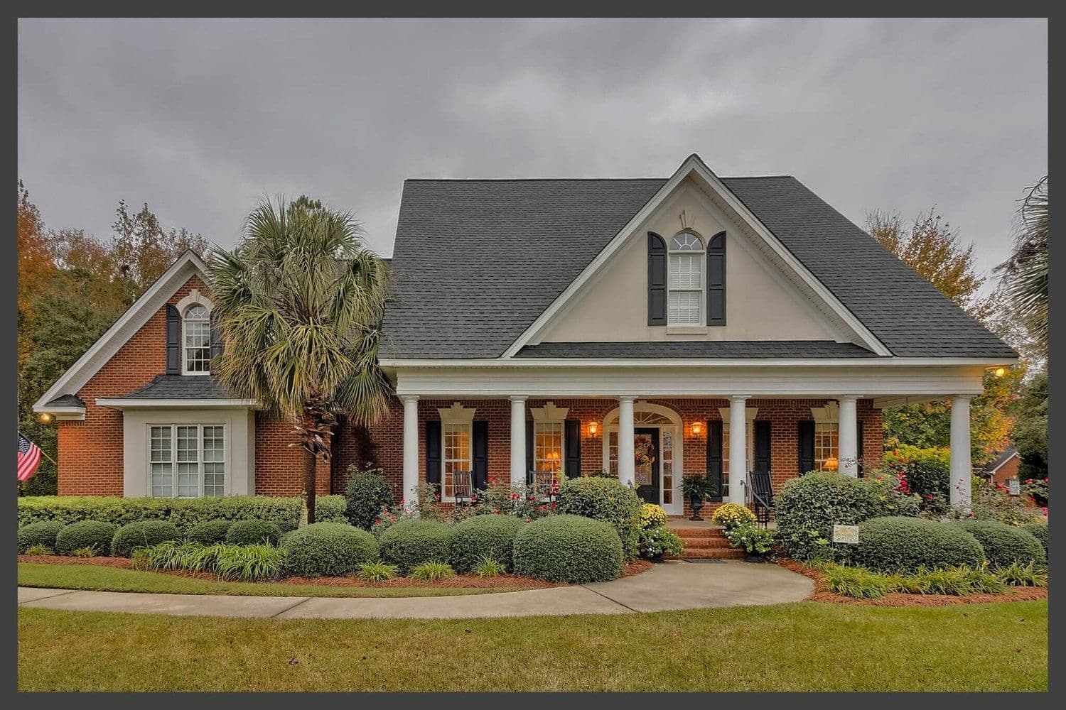 White two-story house with a wide front porch and multiple gables
