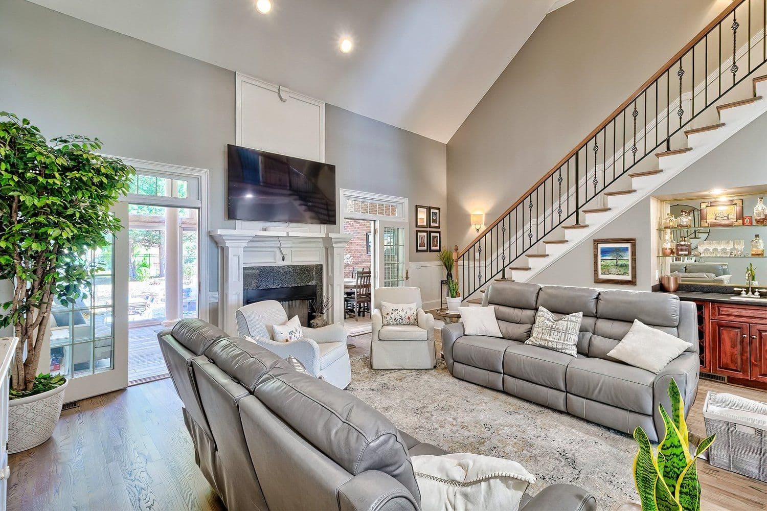 Spacious living room with high ceilings and a grey sectional