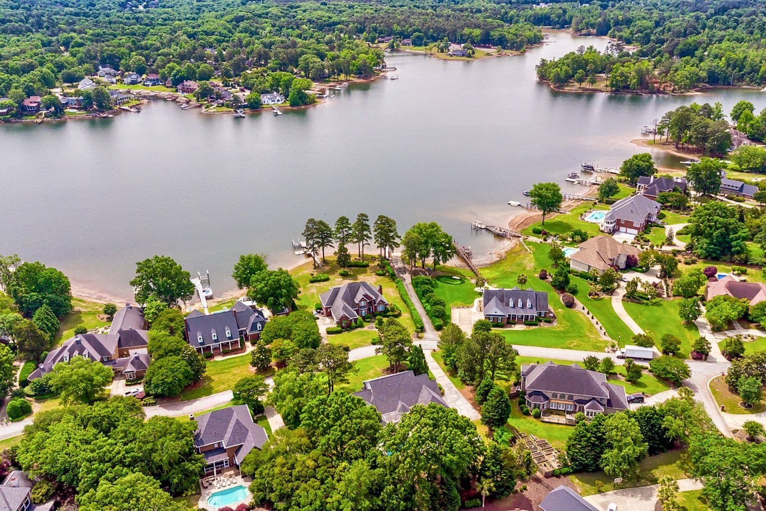 Aerial of lakefront homes with private docks along the water's edge