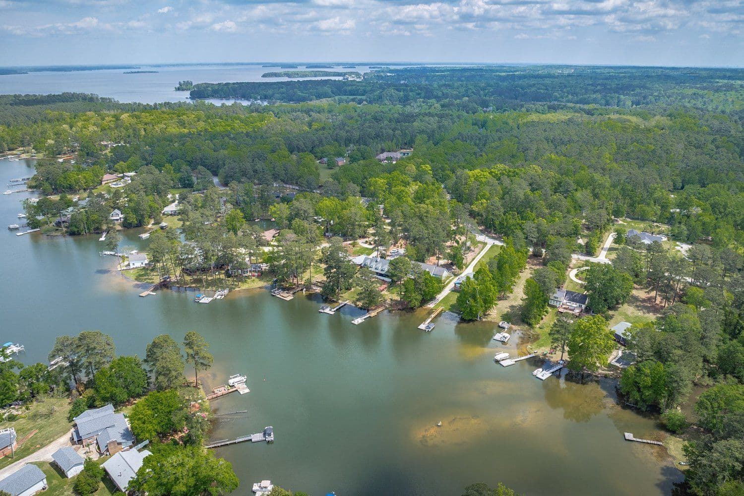 Drone view of lakefront homes and docks on the shoreline
