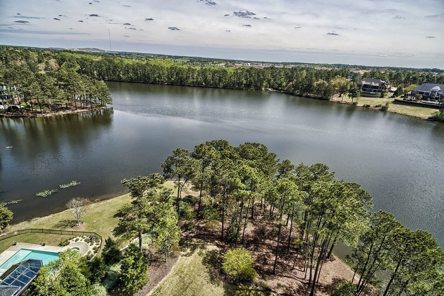 High aerial of Lake Murray with green peninsulas and residential lots