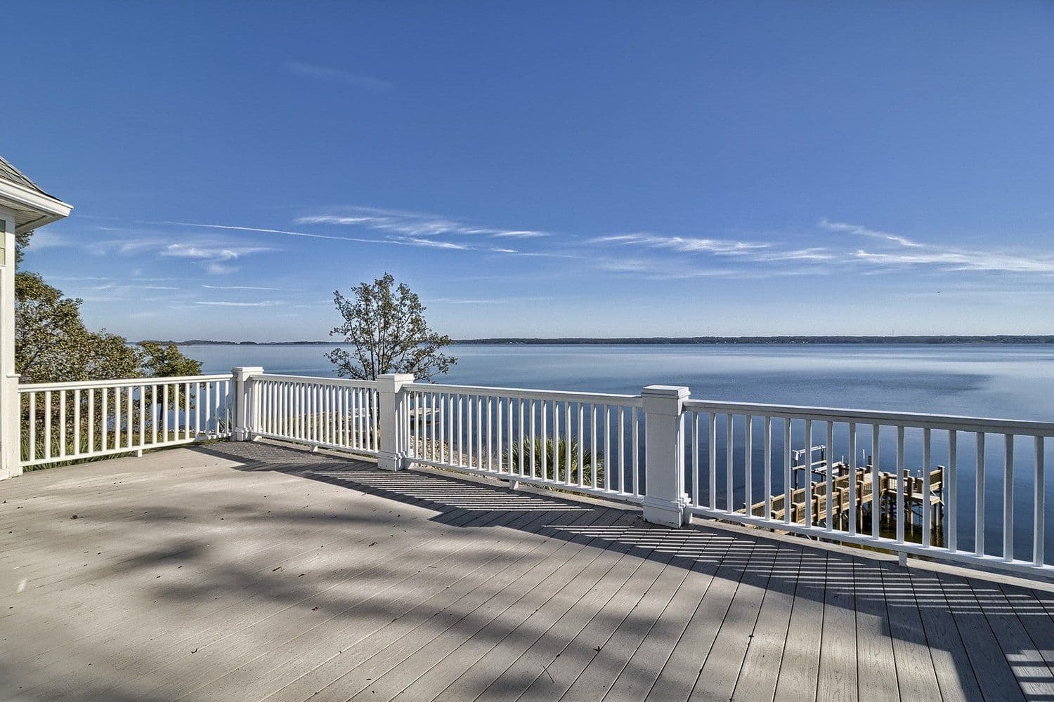 Wide calm lake seen from an elevated white deck