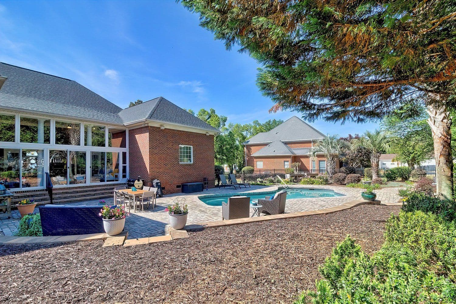 Luxury backyard with pool, brick patio and outdoor seating
