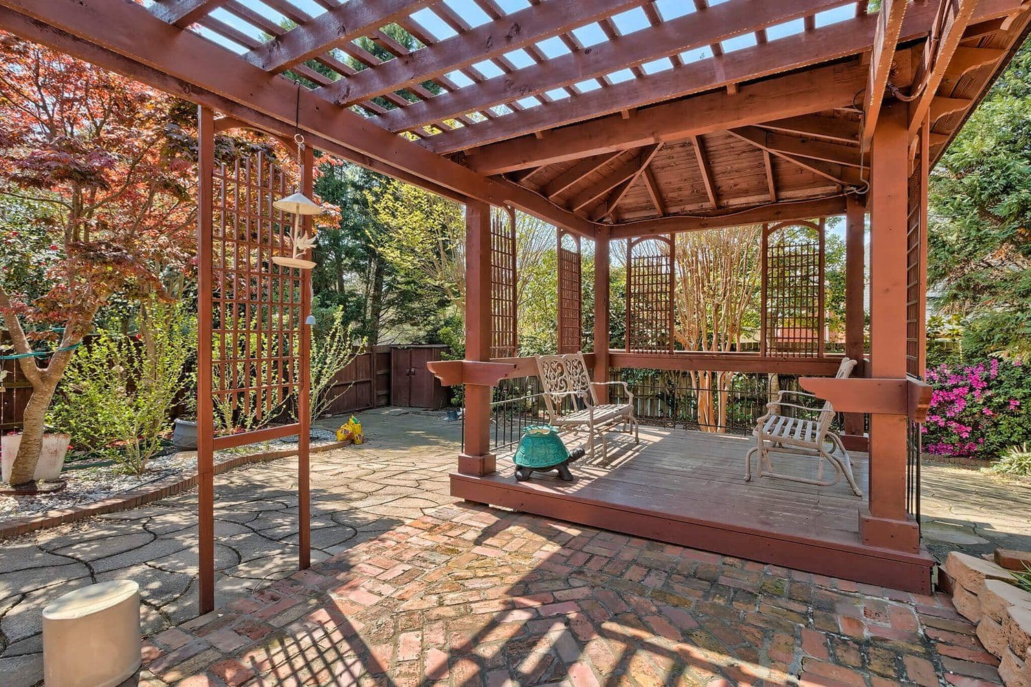 Wooden pergola over a brick-paved patio with outdoor seating