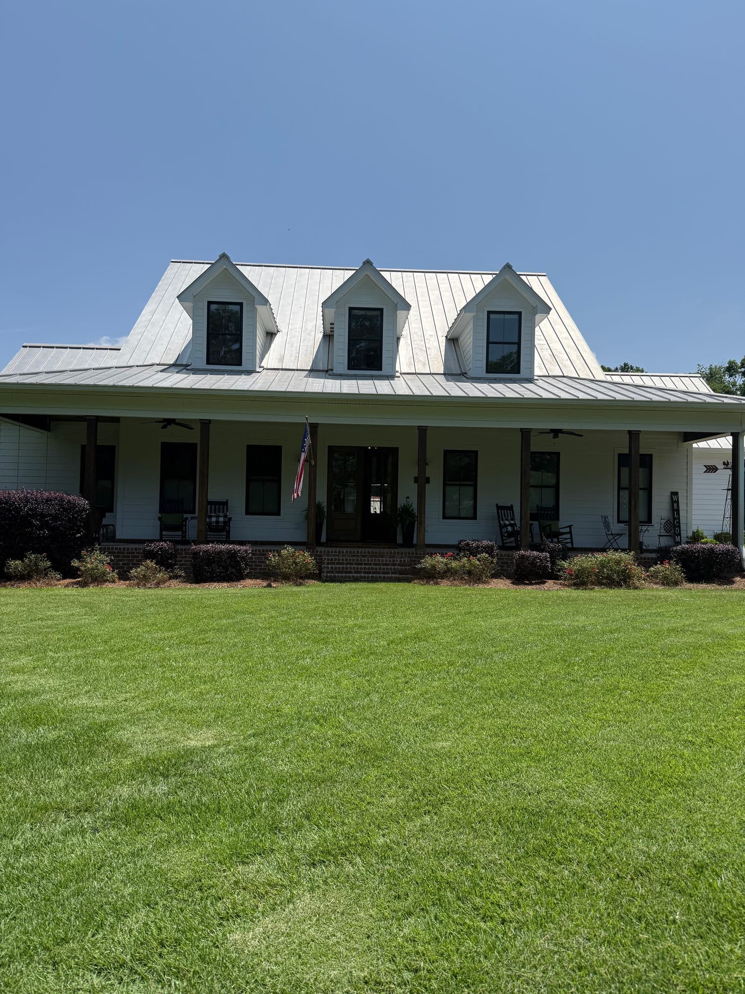 A white house with dormers and a front porch
