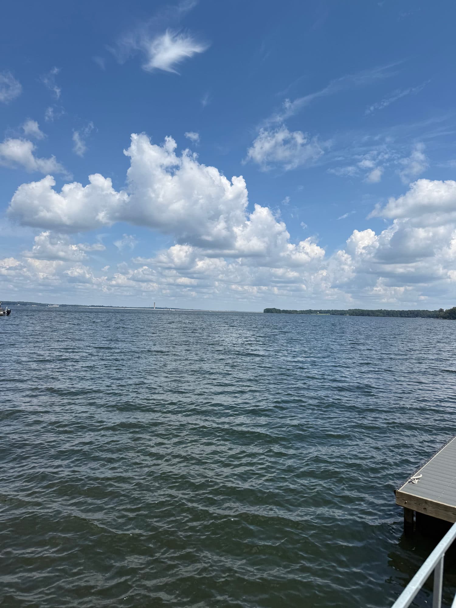 Open water and clouds seen from a dock rail