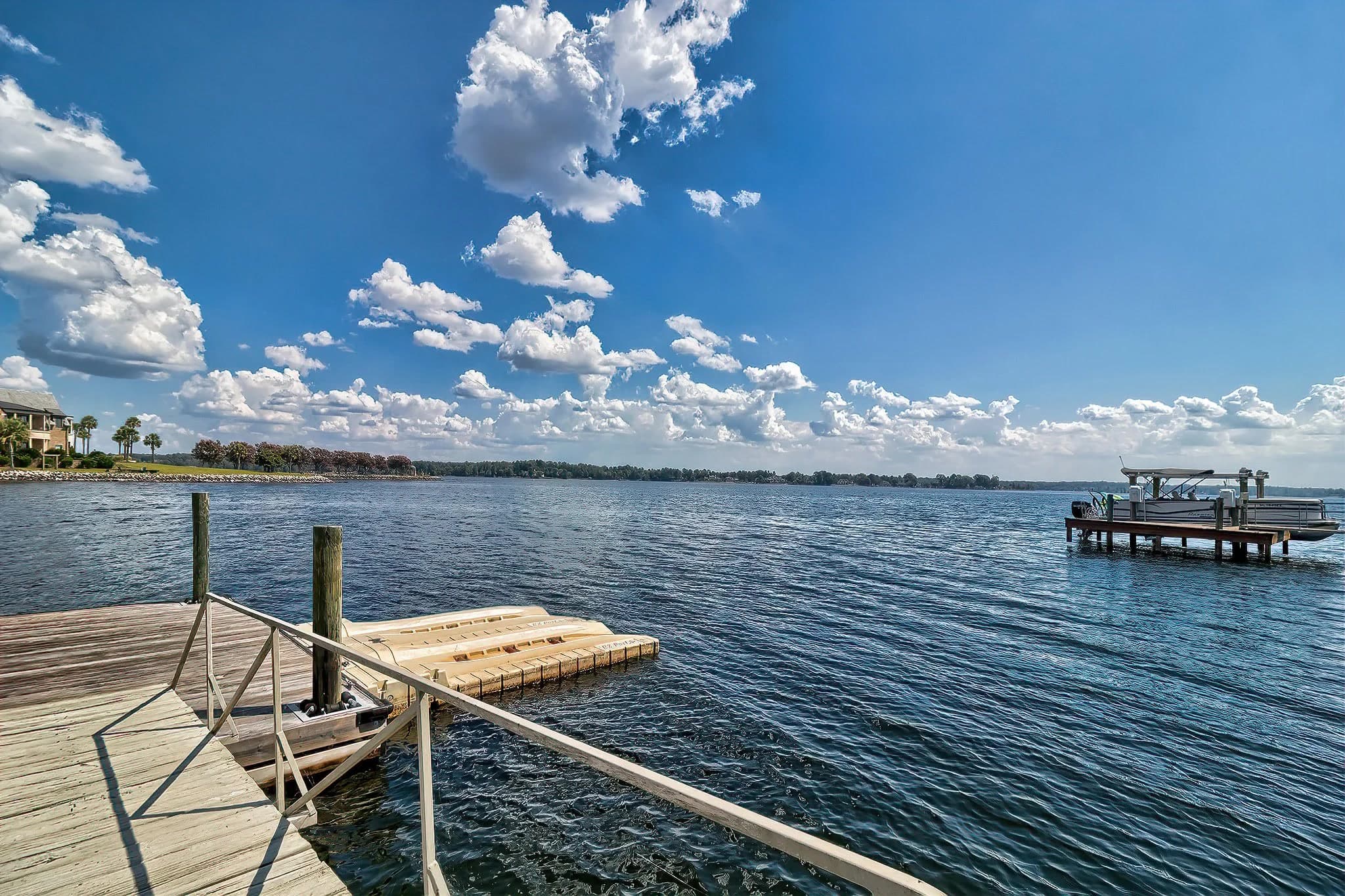 A dock on open water under a bright sky