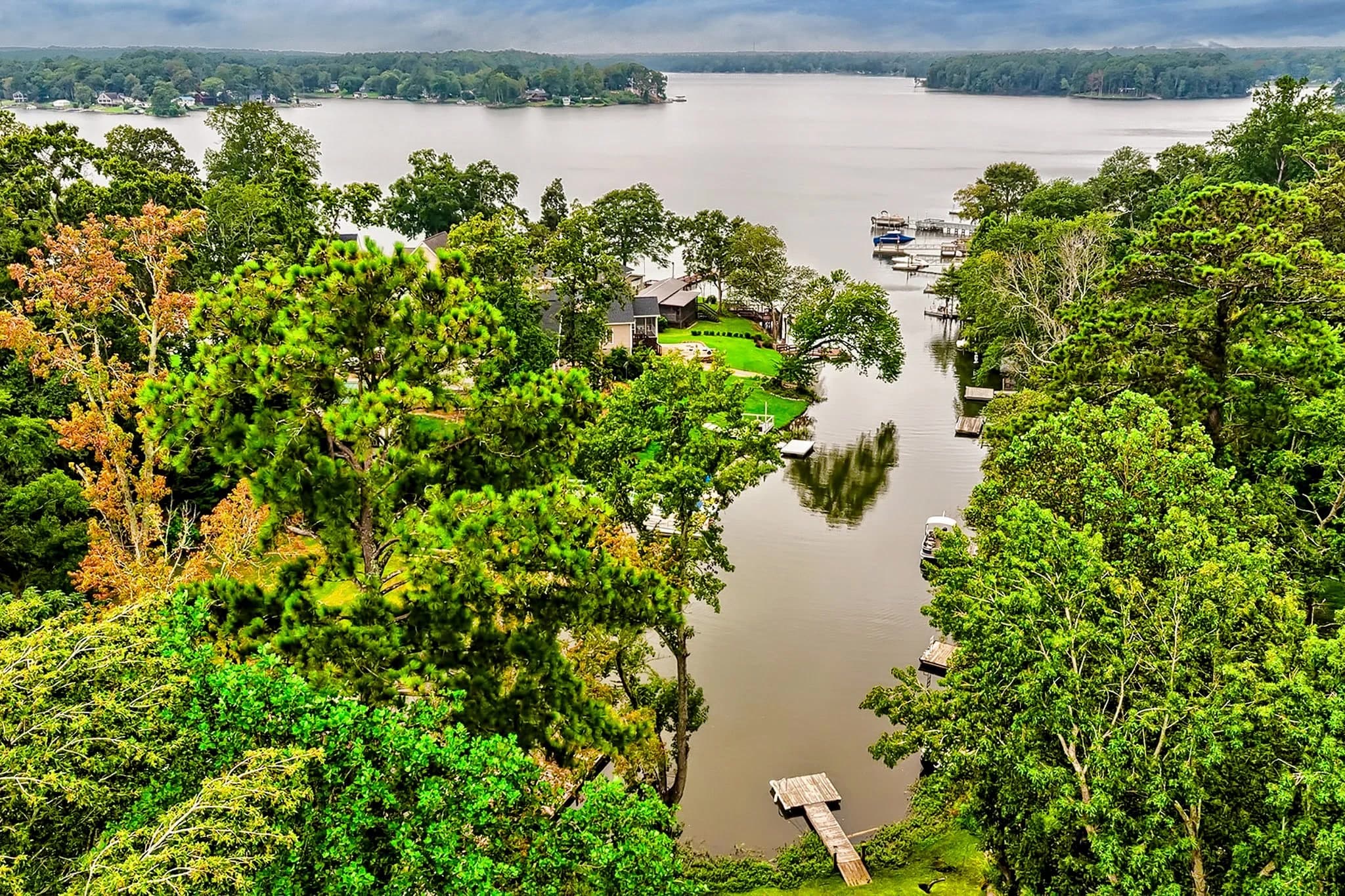 An aerial view of a wooded cove with docks