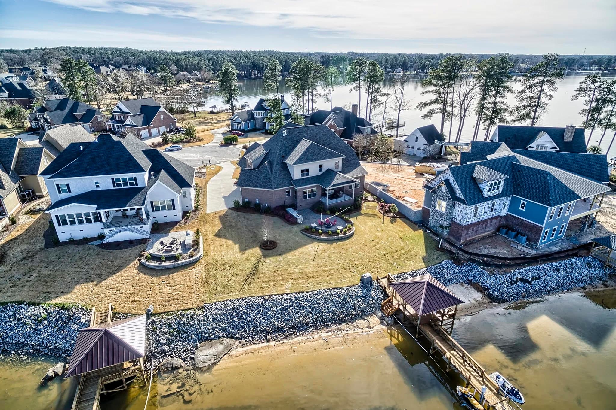 Aerial of waterfront houses with stone patios and docks in Turners Pointe